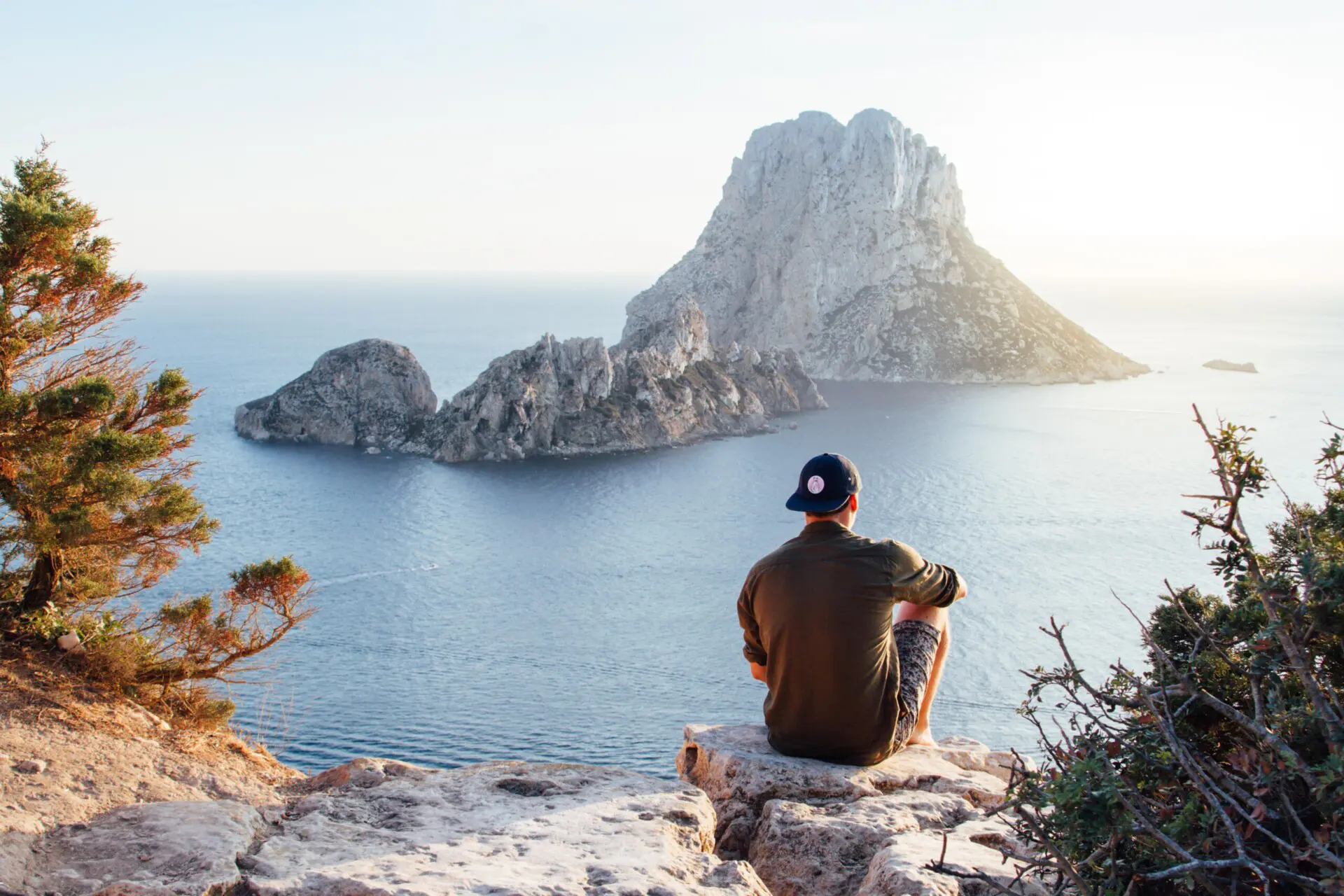 Man on mountain looking at the sea