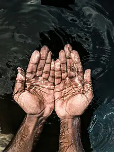 male hands cupping water