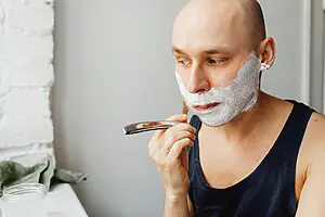 man shaving his face